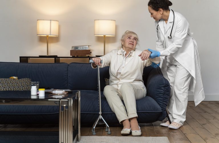 doctor-helping-her-old-patient-stand-up